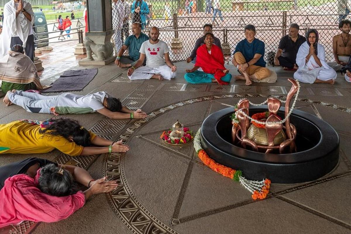 a group of people sitting on the floor around a fire pit