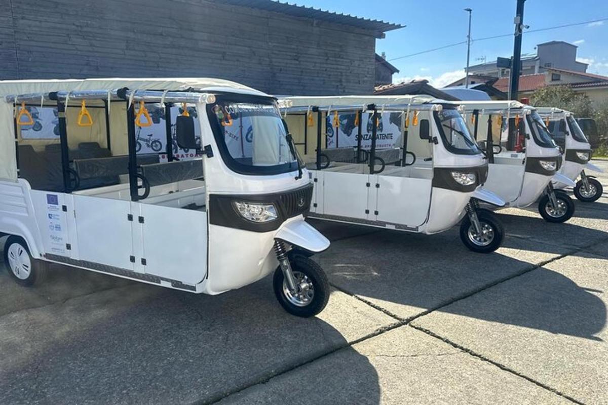 three electric scooters parked in a row in a parking lot