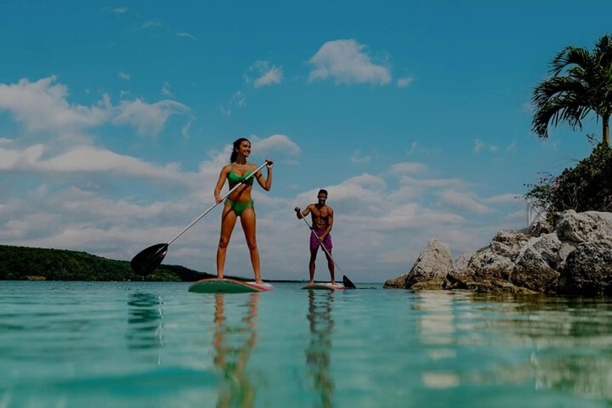 a man and a woman on surfboards in the water