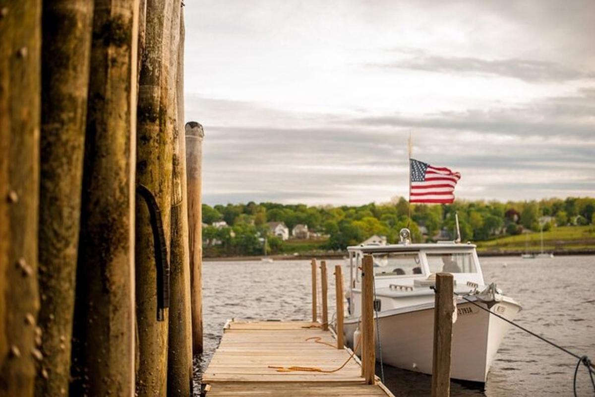 a boat tied to a dock with an american flag