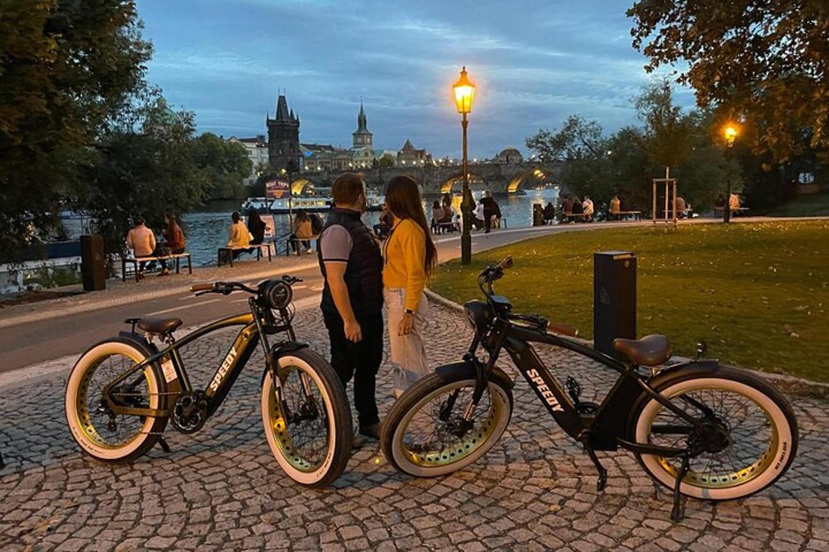 duas pessoas em pé ao lado de suas bicicletas em um parque
