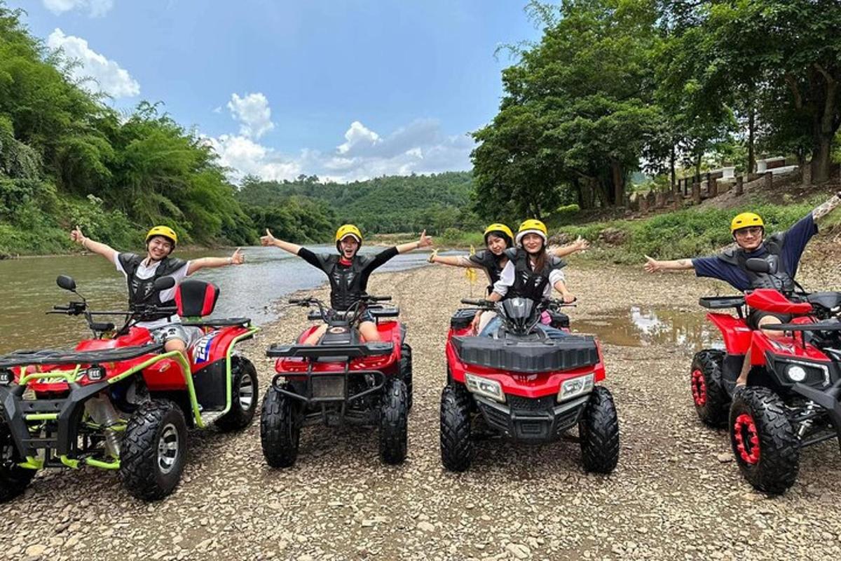 a group of people on at bikes and atvs on a river