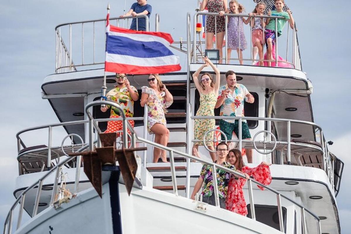 a group of people standing on the deck of a boat