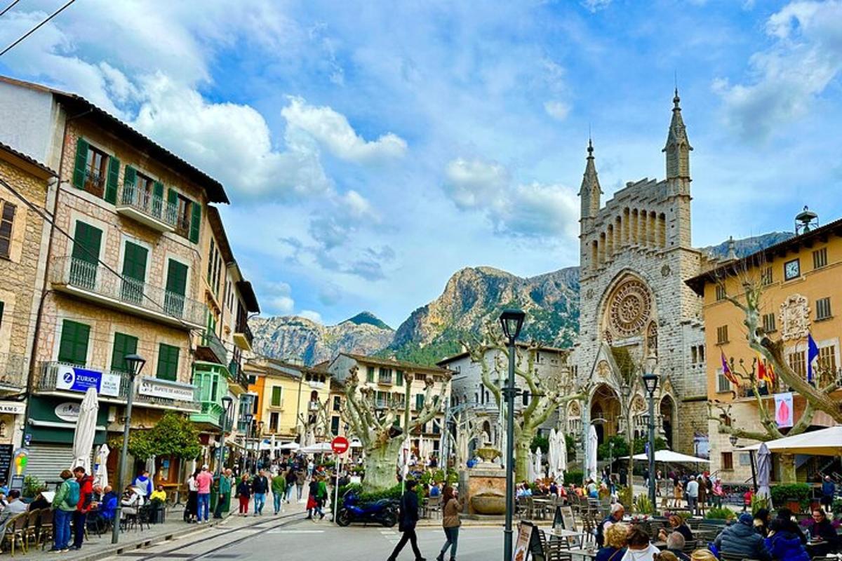 a group of people walking down a city street with a church