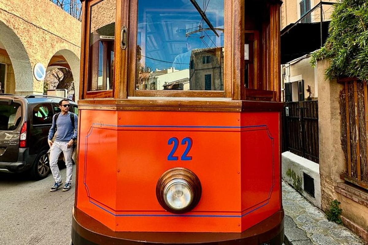 an orange trolley car on a city street