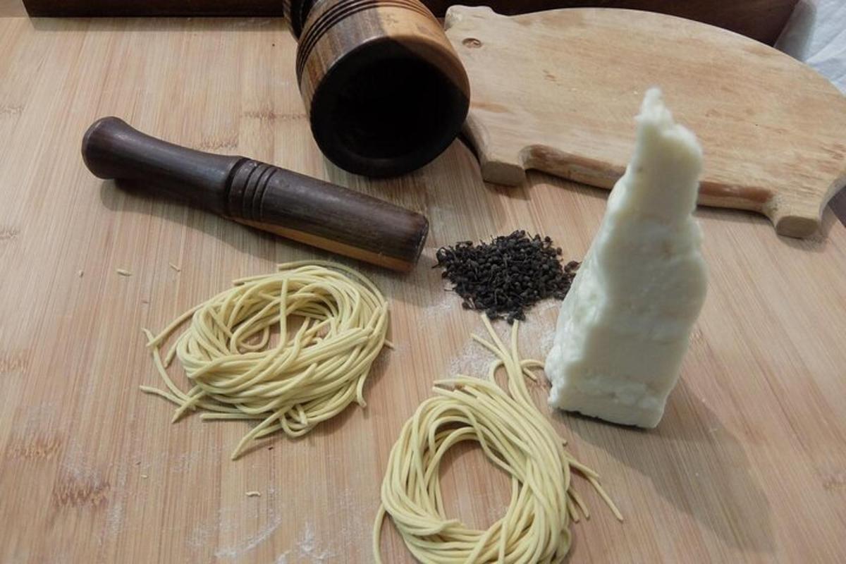 a cutting board with noodles and a bottle of wine