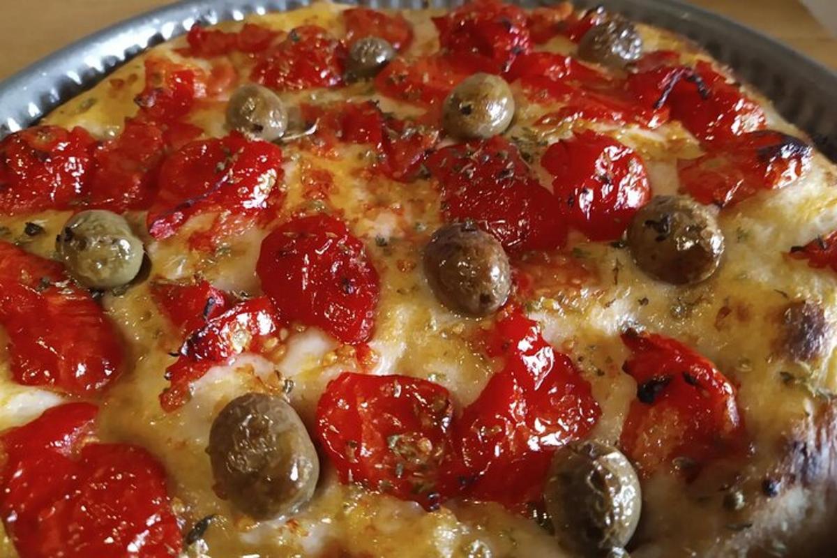 Pizza með pepperoni og ólífum á pönnu