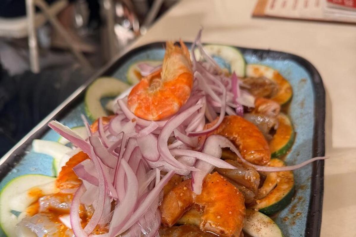 a plate of food with carrots and onions on a table