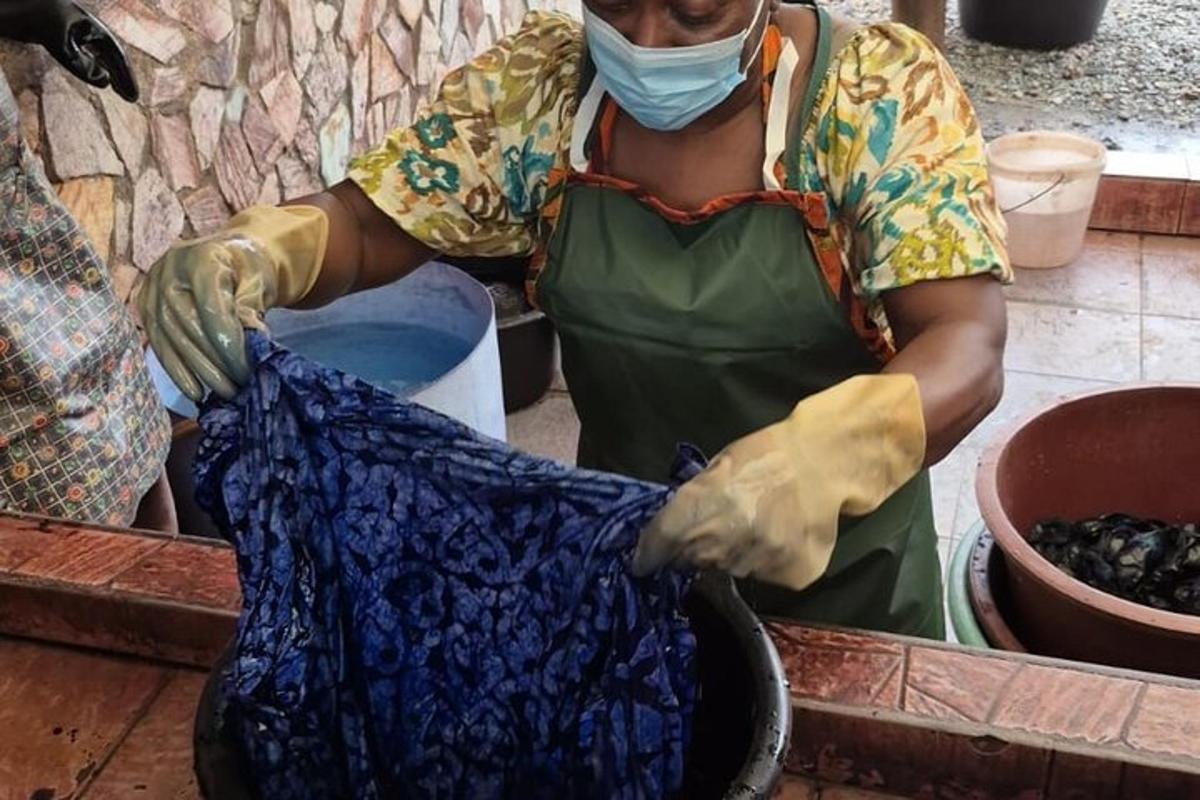 a woman wearing a face mask and holding a piece of cloth