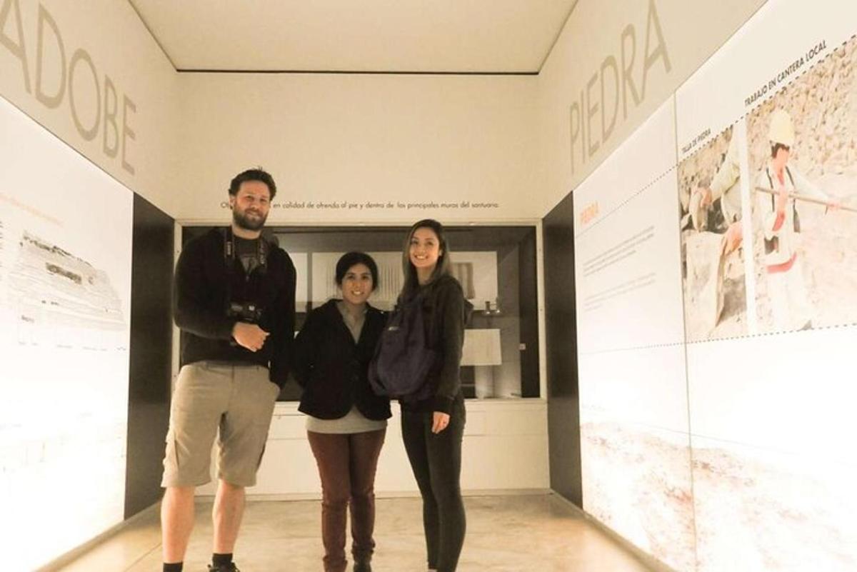 a group of three people standing in a museum