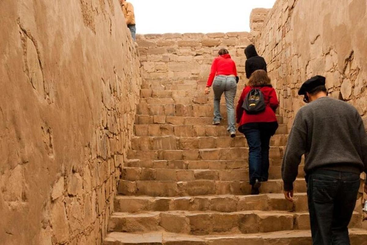people walking up a set of stone stairs