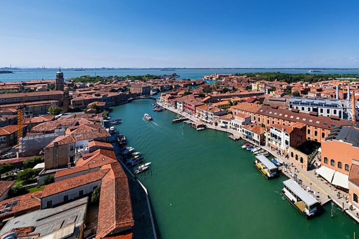 an aerial view of a city with boats in a river