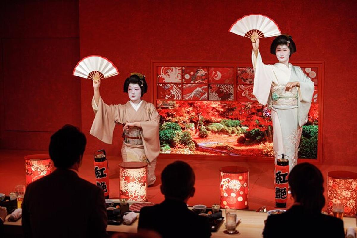 two women are standing on a stage holding umbrellas