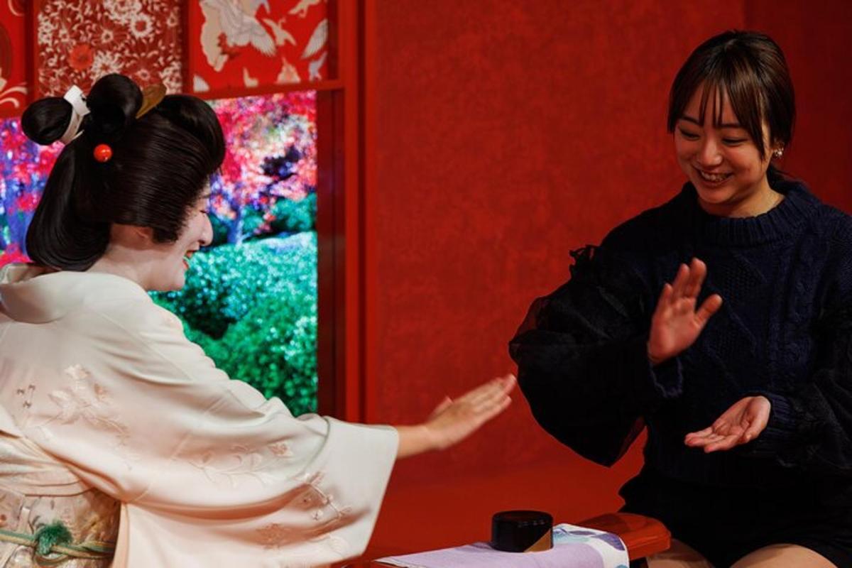 a woman talking to a woman in a room