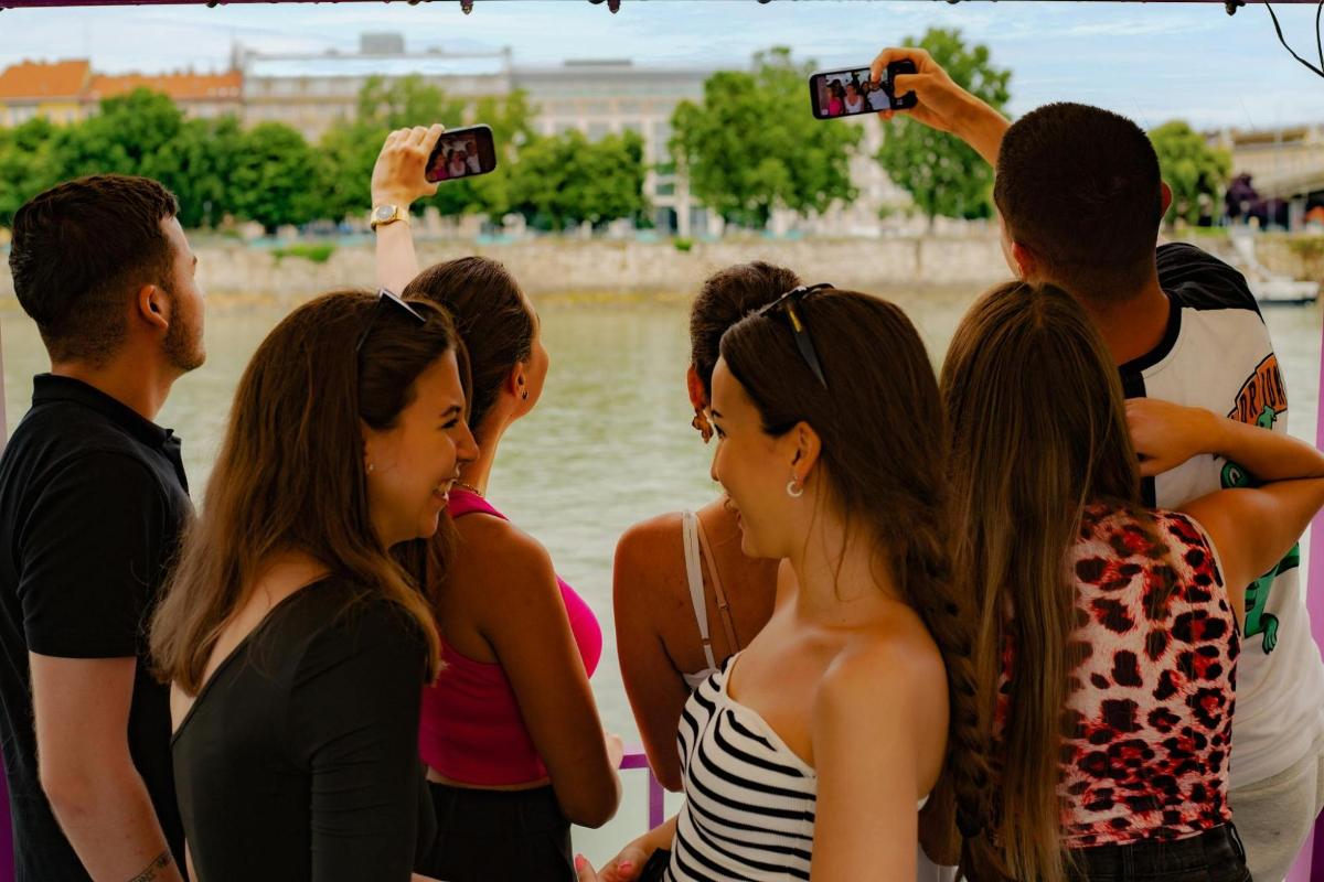 a group of people standing by the water taking pictures
