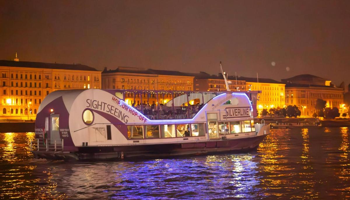 a boat on the water in front of a city