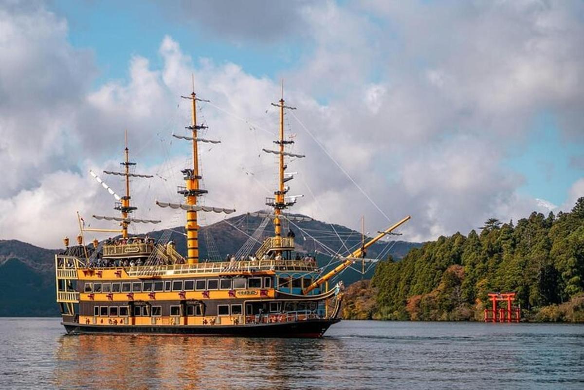 a large ship in the water with a mountain