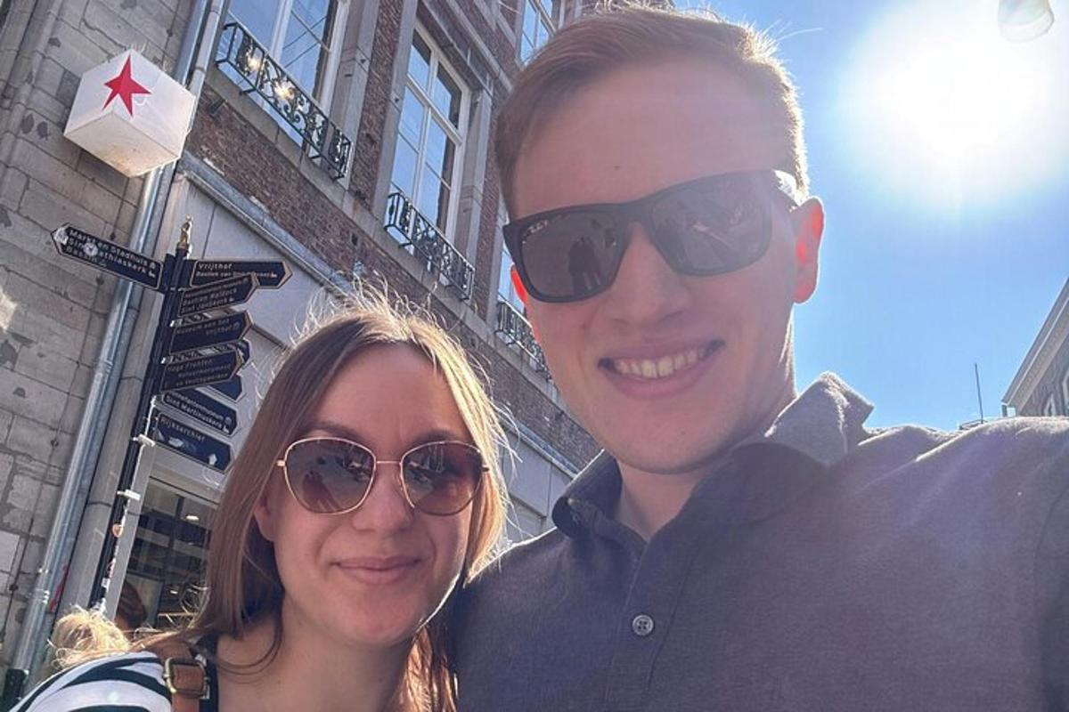 a man and a woman standing in front of a building