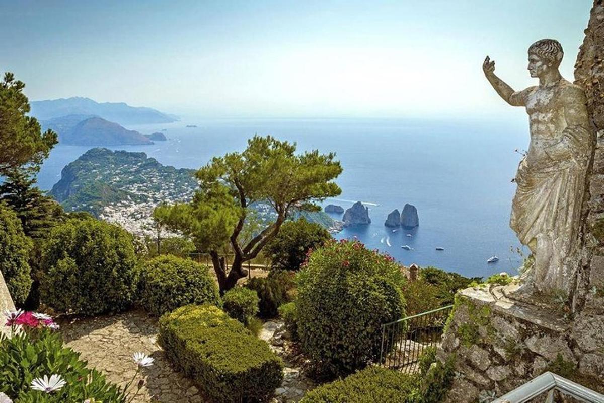 una statua di una donna in piedi su una scogliera che domina l'oceano