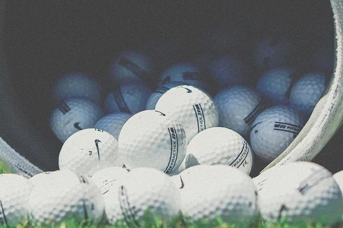a bunch of baseball balls in a basket