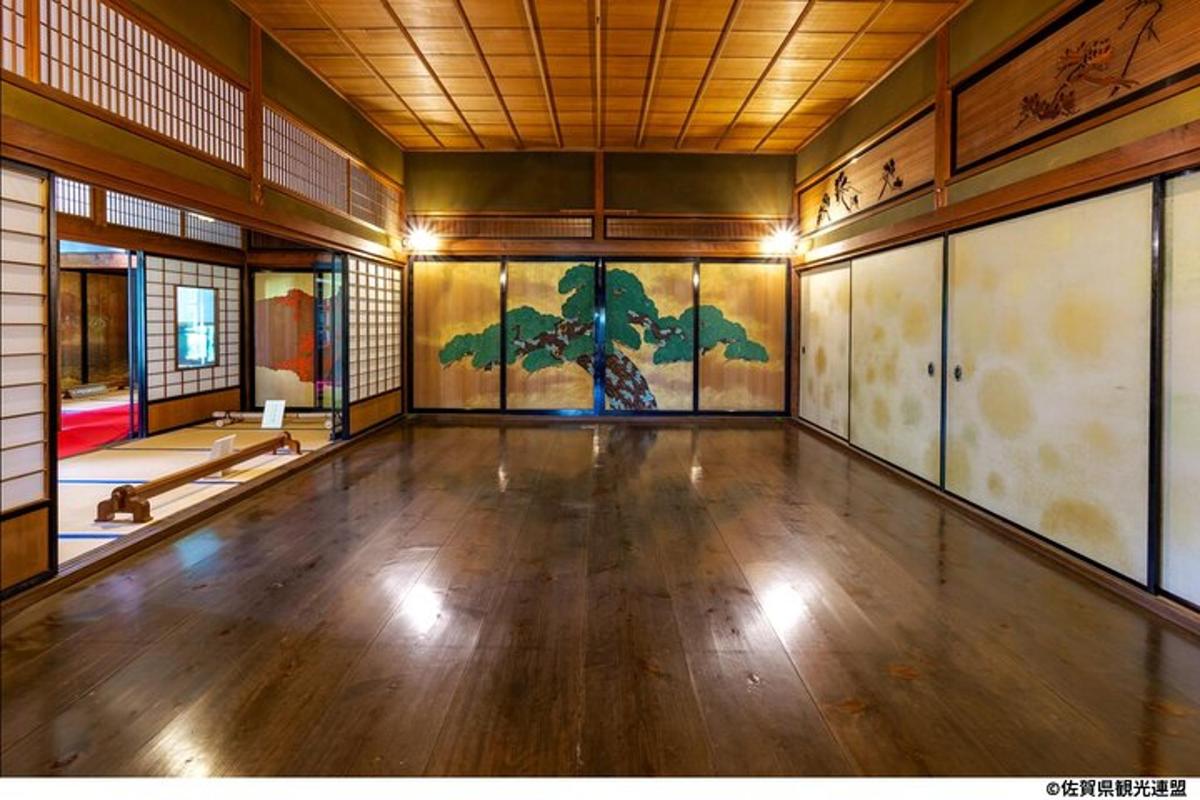 an empty room with a painting on the wall