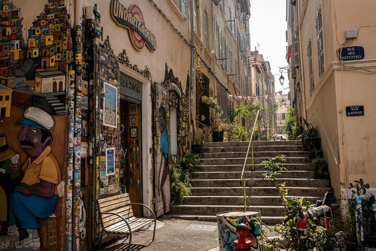an alley with stairs leading up to a building