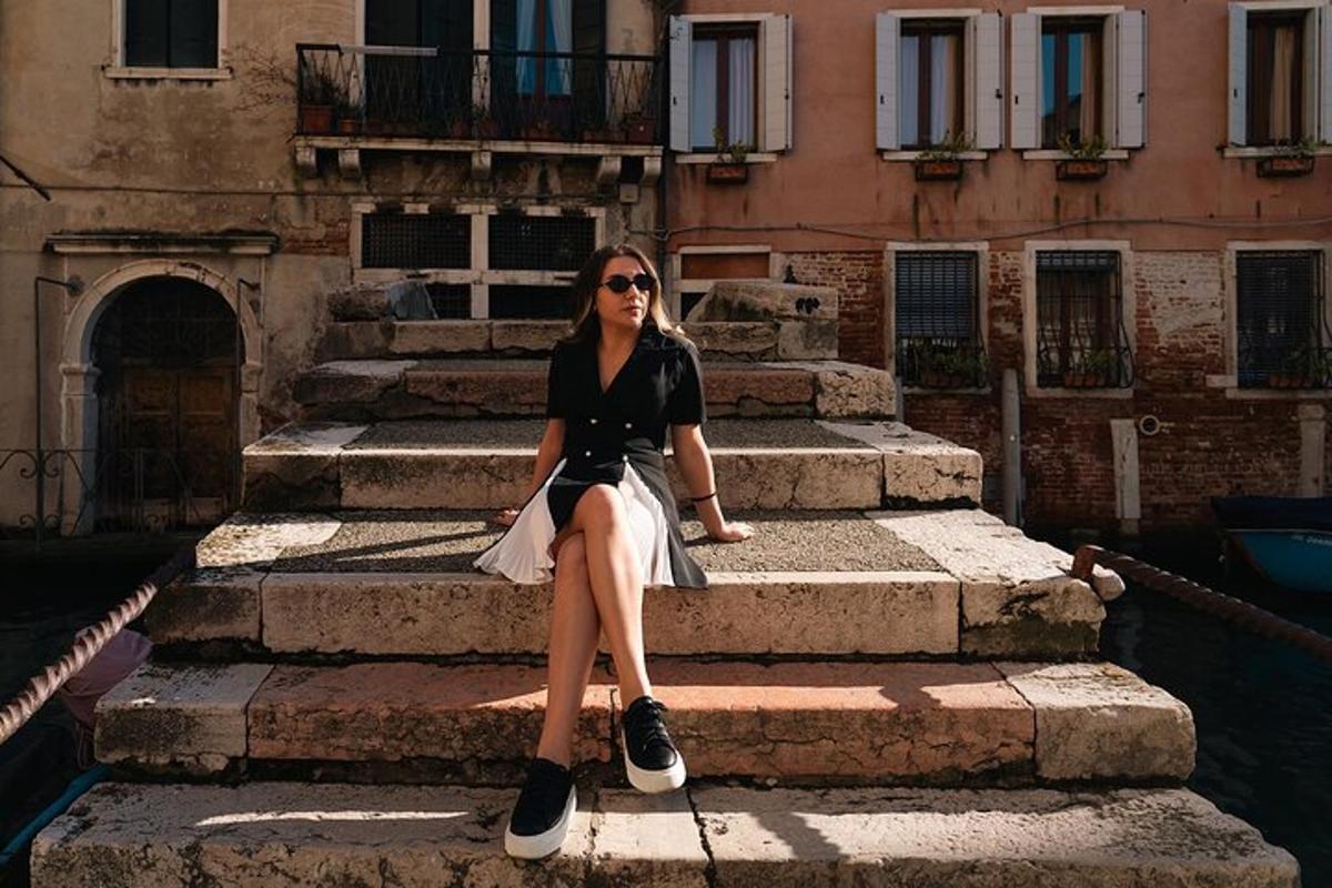 a woman sitting on some steps in front of a building