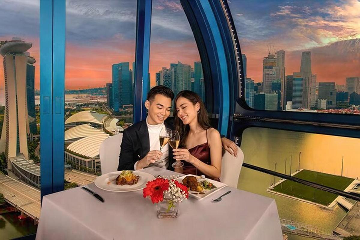 a man and a woman sitting at a table with food