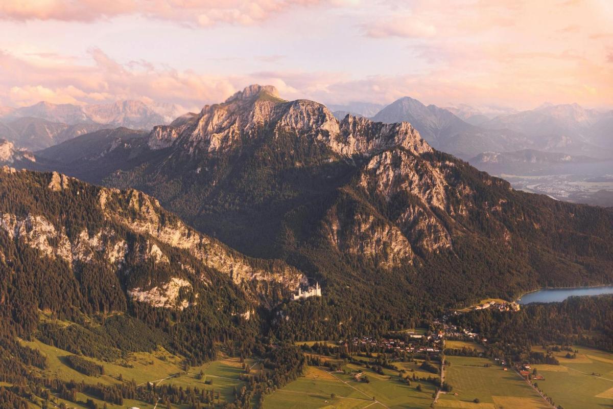 an aerial view of a mountain range with a lake