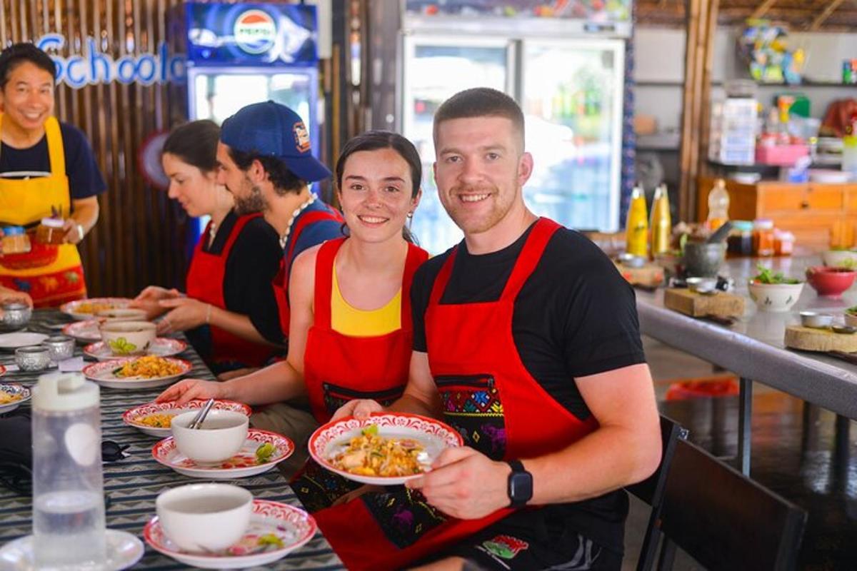 two people sitting at a table with plates of food