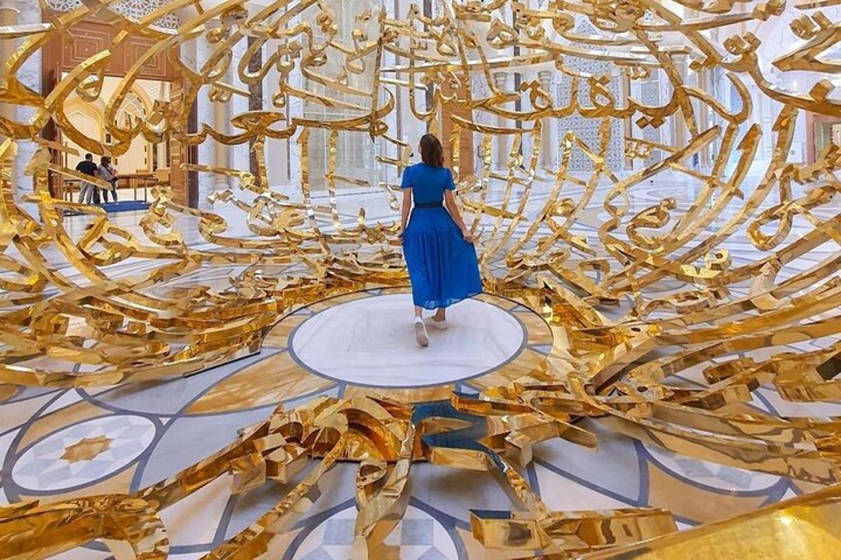 a woman in a blue dress walking in a gold room