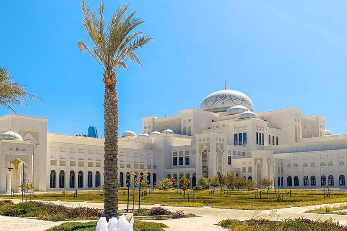 a large building with a palm tree in front of it