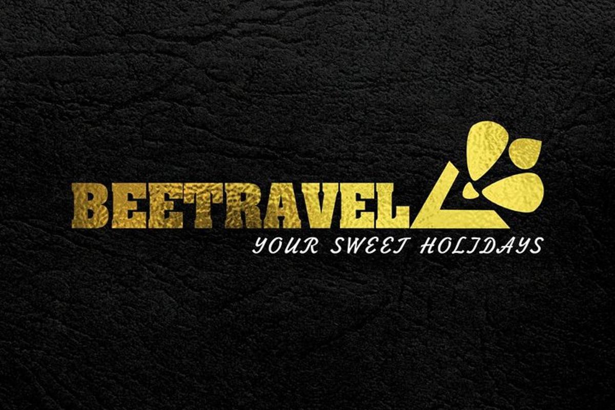 a gold logo with a leaf on a black background