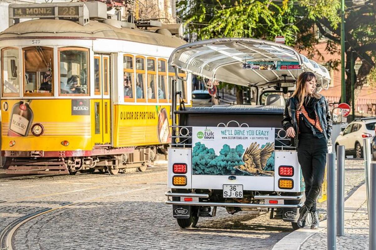 a woman is standing next to a tram