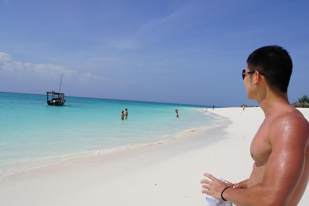 a man standing on a beach in the ocean