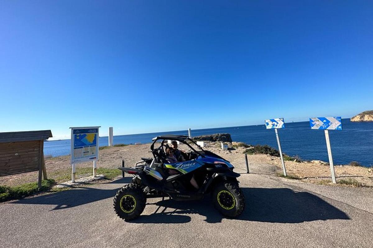 un quad parcheggiato sul ciglio di una strada vicino all'oceano