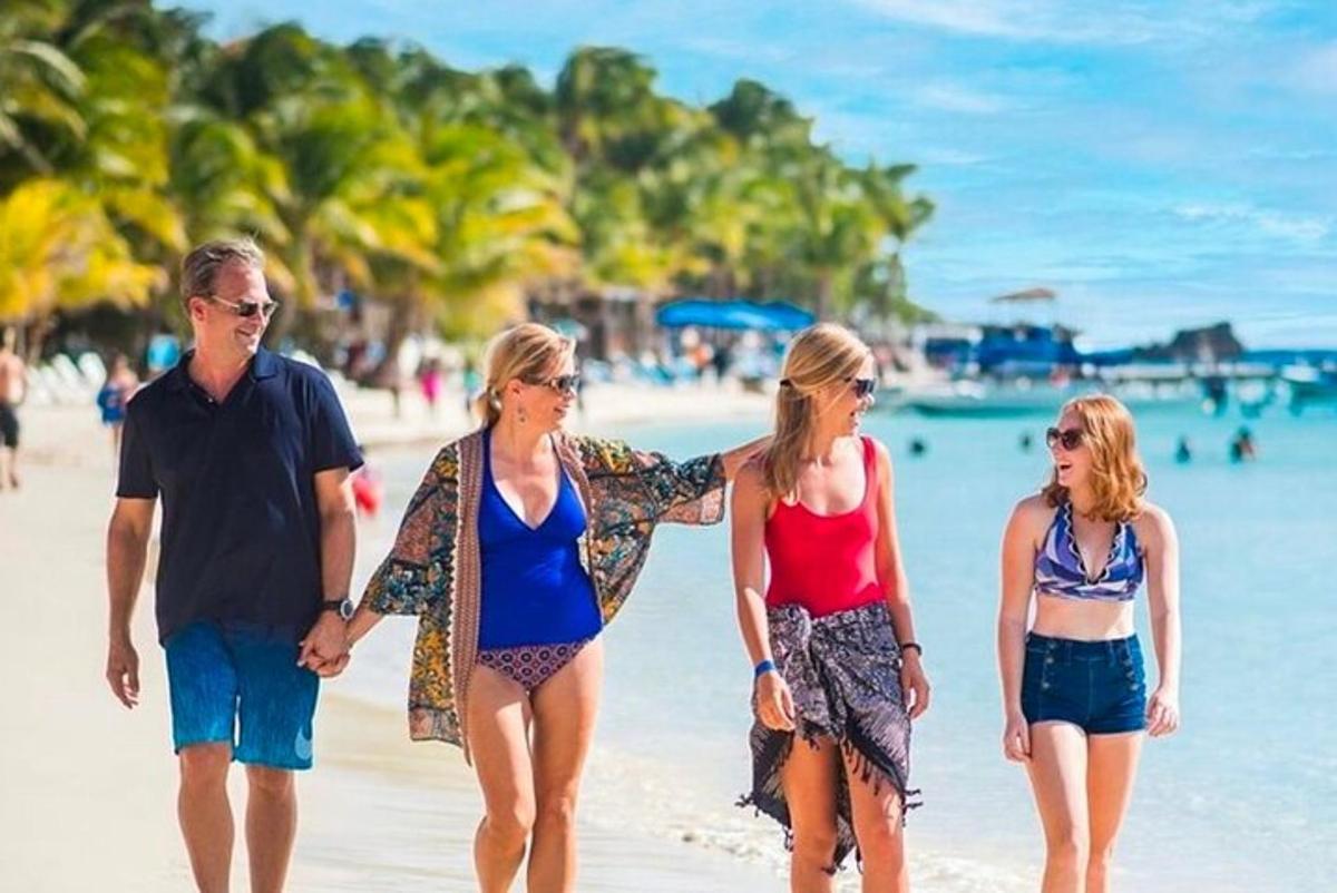 a group of people walking on the beach