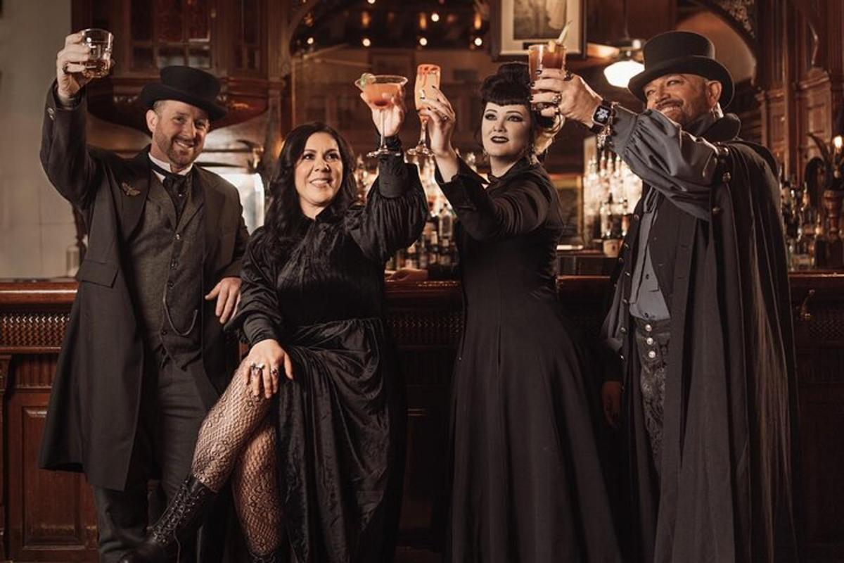 a group of people holding up drinks in a bar