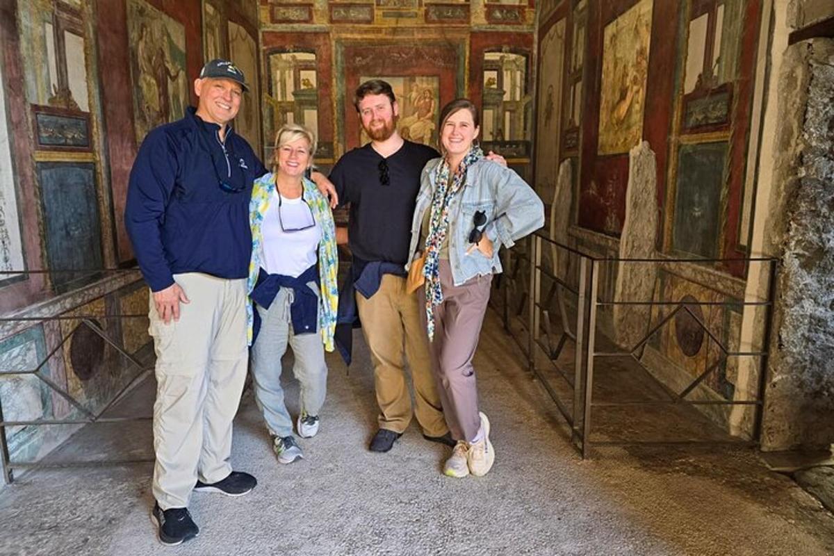 a group of people standing in a room with paintings