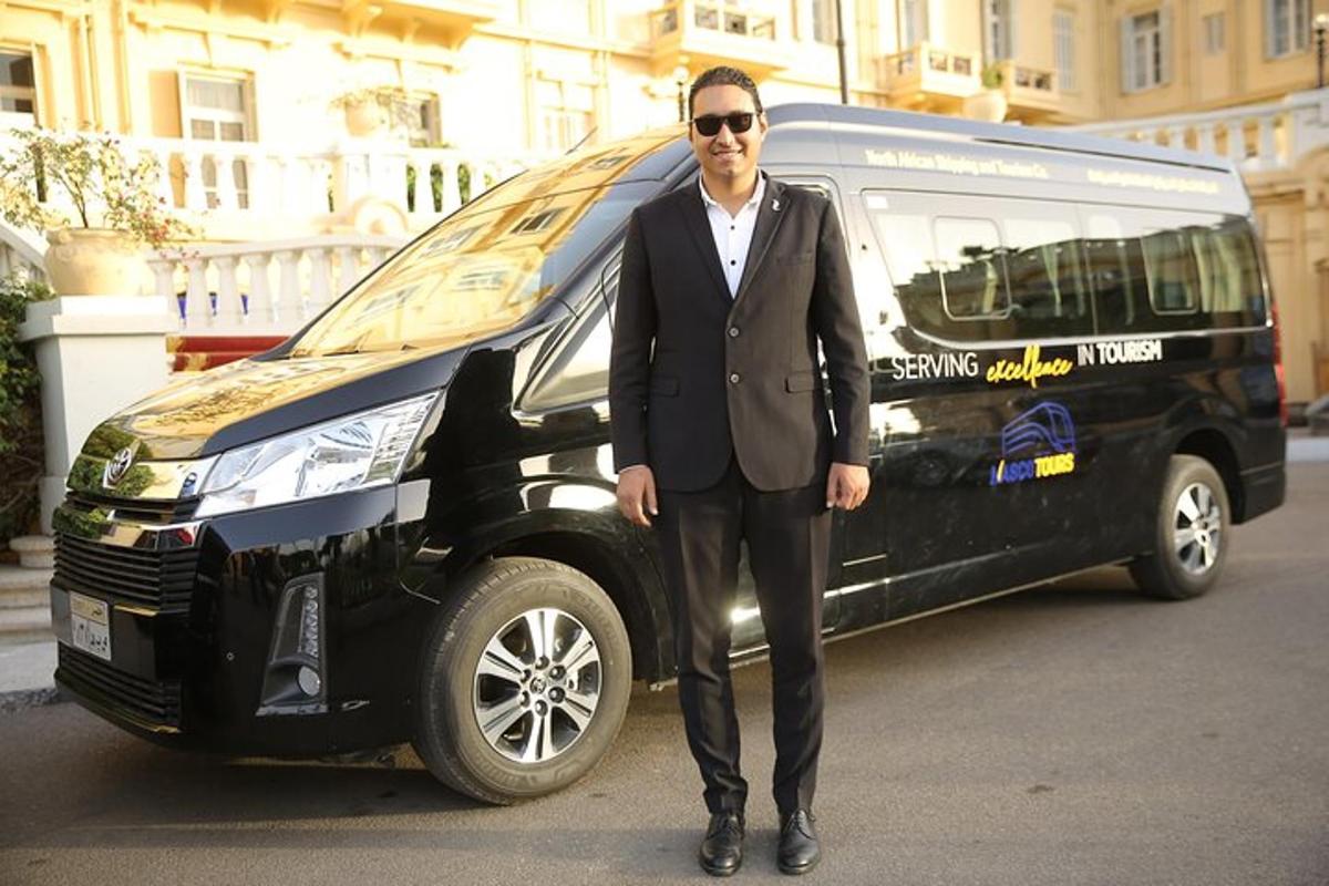 a man in a suit standing next to a van