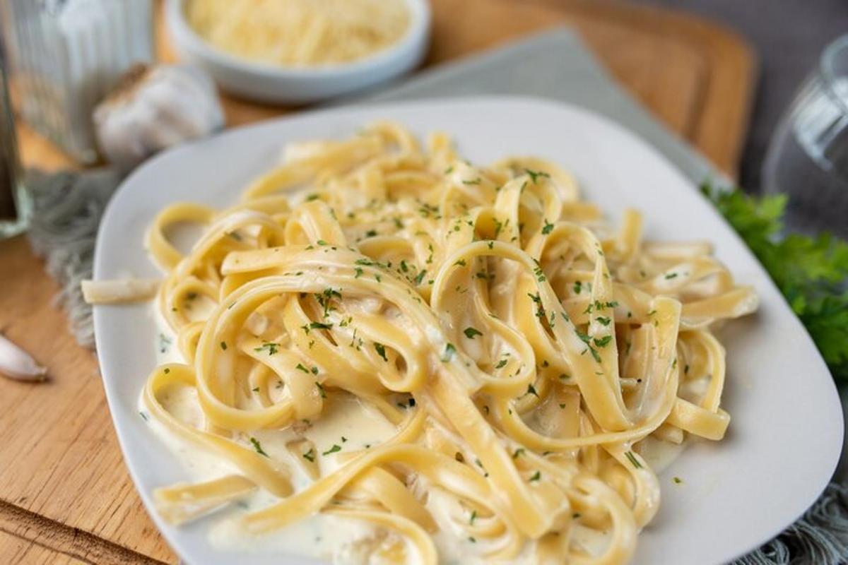 a plate of pasta on a wooden table