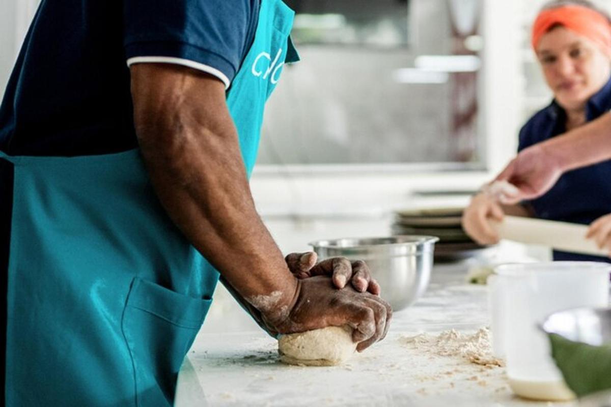 a man in a kitchen kneading a dough