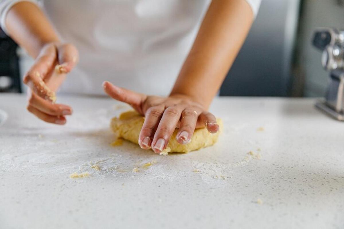 a woman is making a dough on a counter