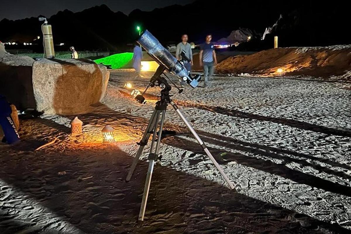 gece vakti sahilde tripod üzerinde bir kamera