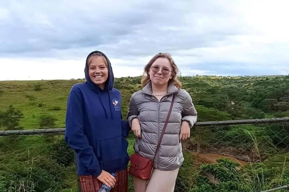 Dos mujeres de pie en la cima de una colina