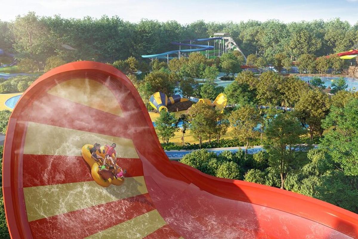 a slide at a theme park with a roller coaster