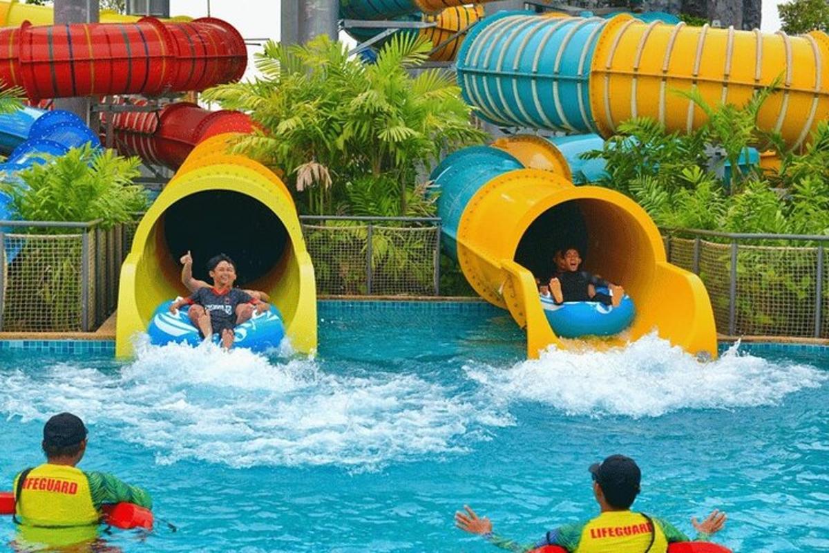 a group of people riding on a water slide at a water park