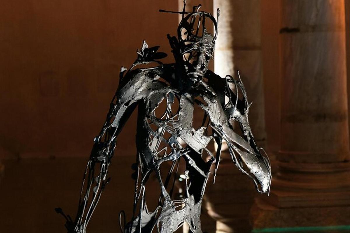 a metal sculpture of a person wearing a costume