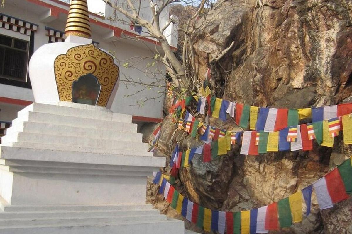 a temple with prayer flags in front of a mountain