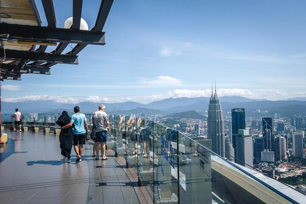 a group of people standing on the observation deck of a building